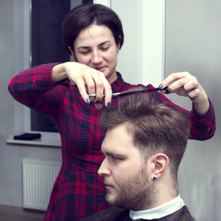 The young man at the hairdresser salon hairstyle make modelの写真素材