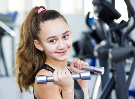 Girl is engaged in sports and gymnastics in the gymの写真素材