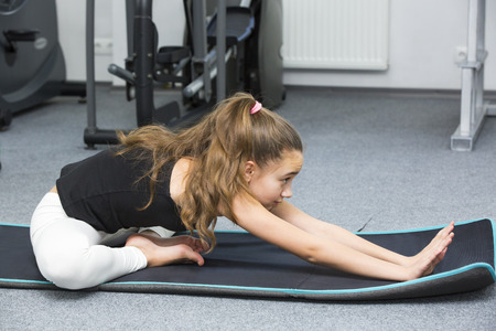 Girl is engaged in sports and gymnastics in the gymの写真素材