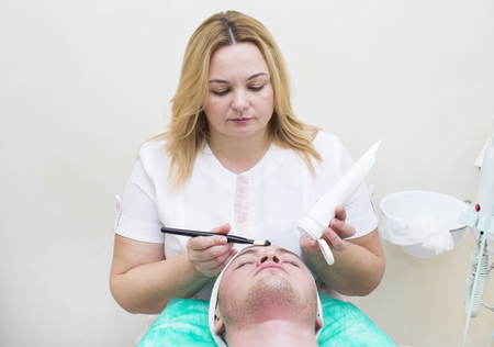man in the mask cosmetic procedure in spa salonの写真素材