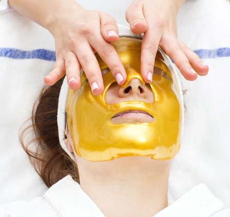 gold mask cosmetic procedure in the beauty salonの写真素材