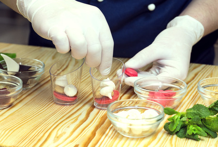 cook prepares canapes in the kitchen at the restaurantの写真素材