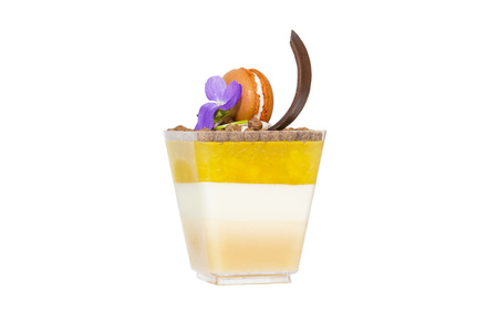 mini canapes in plastic cups decorated with edible flowersの写真素材