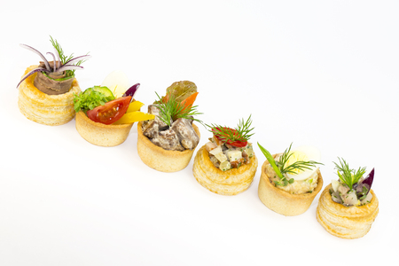 Canape with meat and vegetables in plastic cupsの写真素材