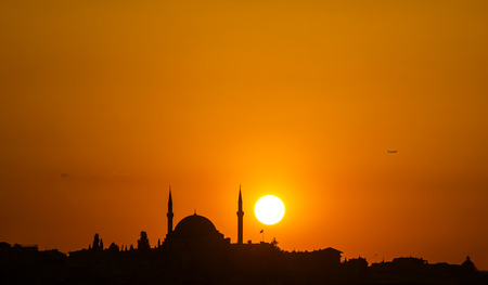 The old mosque and minaret at sunset in Istanbulの写真素材