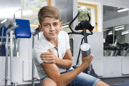 Teenage boy engaged in the gym hallの写真素材