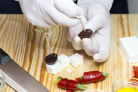 cooking mini canapes of meat and vegetable saucesの写真素材
