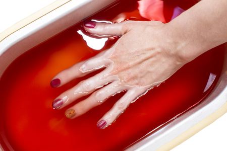 Process paraffin treatment of female hands in beauty salonの写真素材