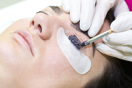 Woman on the procedure for eyelash extensions, eyelashes laminationの写真素材