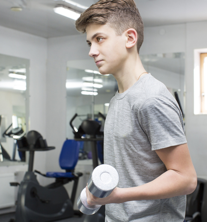 Teenage boy engaged in the gym hallの写真素材