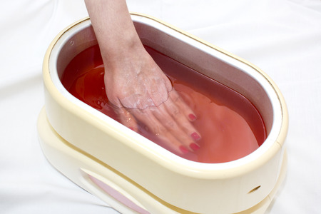 Process paraffin treatment of female hands in beauty salonの写真素材