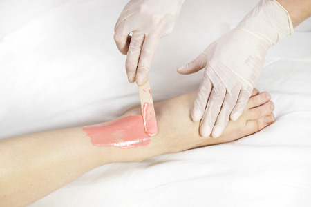 Process depilation female legs and hands in a beauty salonの写真素材