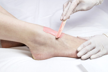 Process depilation female legs and hands in a beauty salonの写真素材