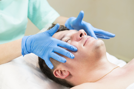 man in the mask cosmetic procedure in spa salonの写真素材