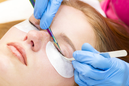 Woman on the procedure for eyelash extensions, eyelashes laminationの写真素材