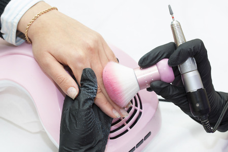 Woman doing manicure beauty salonの写真素材