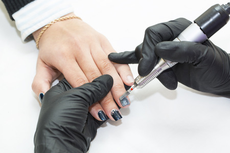 Woman doing manicure beauty salonの写真素材