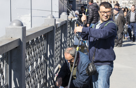 ISTANBUL, TURKEY - 1 APRIL, 2017: Fishermen on the Galata Bridge fish in the Golden Horn Bay Turkeyのeditorial素材
