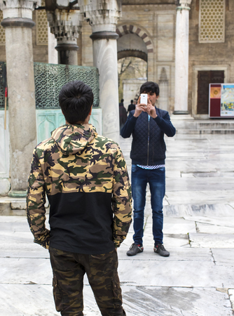 ISTANBUL, TURKEY - 7 APRIL, 2017: Tourists are photographed and make a blue mosque in the city of Istanbulのeditorial素材