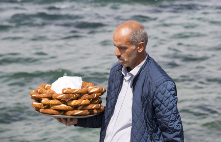 ISTANBUL, TURKEY - 5 APRIL, 2017: Street sales of traditional Turkish bagels Simit, are on the...