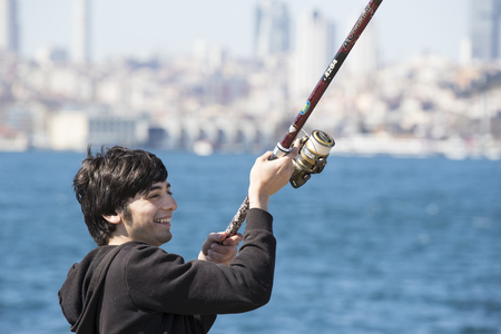 ISTANBUL, TURKEY - 3 APRIL, 2017: Fishermen are fishing on the banks of the Bosphorus in Istanbul Turkeyのeditorial素材