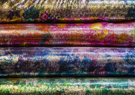 Background of the scrolls rolls colored colorful fabric