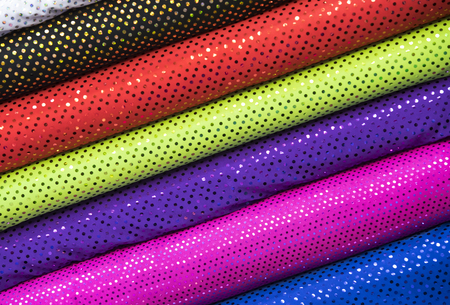 Background of the scrolls rolls colored colorful fabric