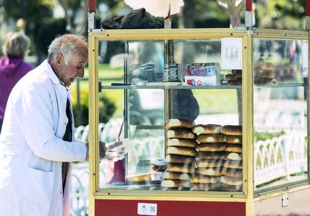 ISTANBUL, TURKEY - 1 APRIL, 2017: Street sales of traditional Turkish bagels Simit, are on the...