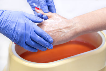 Process paraffin treatment of female hands in beauty salonの写真素材