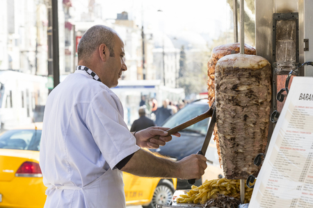 ISTANBUL, TURKEY - 1 APRIL, 2017: Man cooks Turkish meat kebab at a street cafeのeditorial素材