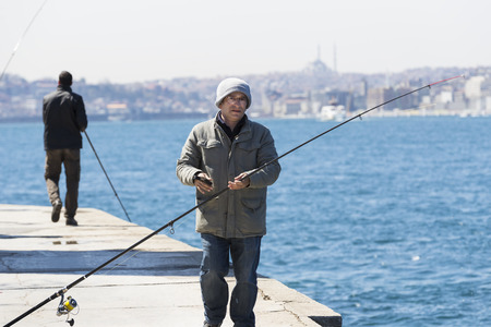 ISTANBUL, TURKEY - 1 APRIL, 2017: Fishermen are on the banks of the Bosphorus in Istanbul Turkeyのeditorial素材