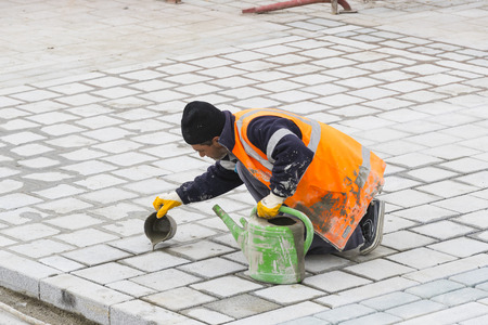 STANBUL, TURKEY - 4 APRIL 2017: Road workers repair the sidewalk in Istanbul near the Galata Bridgeのeditorial素材