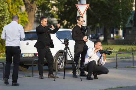 BUDAPEST, HUNGARY. 23 JUNE, 2017: A group of wedding photographers on the streets of Budapest is holding a photo session for a couple of newlyweds.のeditorial素材