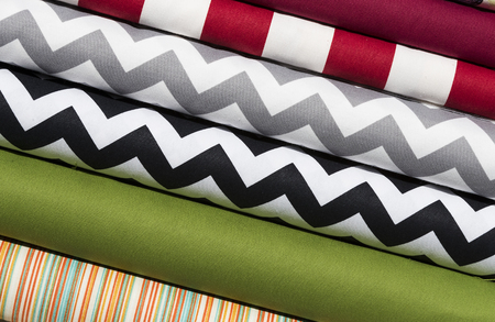 Colorful fabric scarves in stack as background