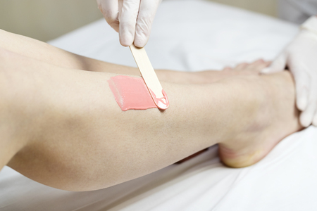 Process depilation female legs and hands in a beauty salonの写真素材