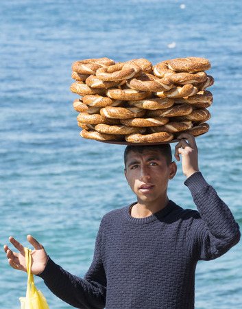 ISTANBUL, TURKEY - 1 APRIL, 2017: Street sales of traditional Turkish bagels Simit, are on the...