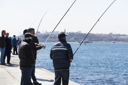 ISTANBUL, TURKEY - 3 APRIL, 2017: Fishermen are fishing on the banks of the Bosphorus in Istanbul Turkeyのeditorial素材
