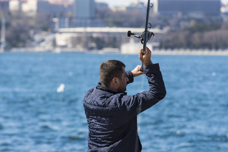 ISTANBUL, TURKEY - 3 APRIL, 2017: Fishermen are fishing on the banks of the Bosphorus in Istanbul Turkeyのeditorial素材