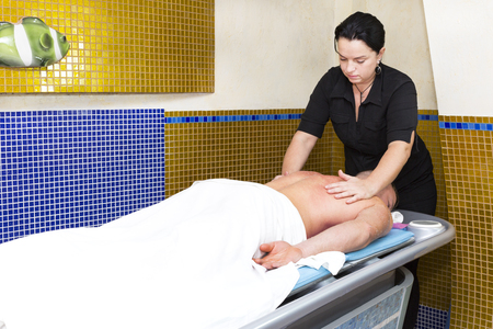 The process of sports massage is made by a man in a massage salonの写真素材