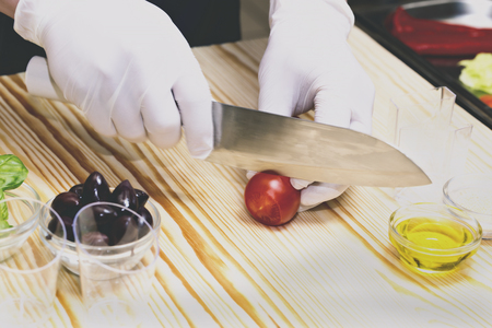 Cook cooking canapes in the kitchen at the restaurantの写真素材