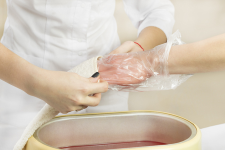 Process paraffin treatment of female hands in beauty salonの写真素材