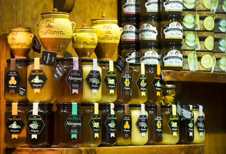 BARCELONA, SPAIN - 11 JANUARY 2018: Products on food shelves in the oldest market of Barcelona Boqueria selling food jamon vegetables for tourists and visitors to the city.のeditorial素材