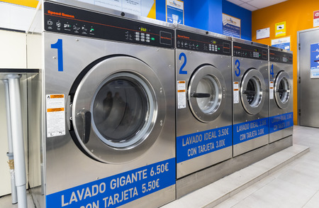 MADRID, SPAIN - 27 MARCH, 2018: Public laundry with mashinam for a street in the city of Madrid.のeditorial素材