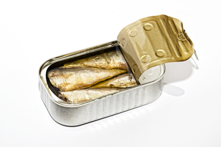 Open can with canned seafood closeup on a white backgroundの写真素材