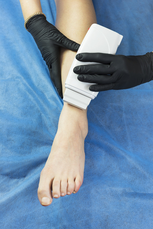 Process depilation female legs and hands in a beauty salonの写真素材