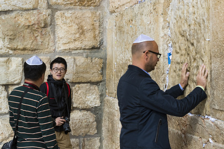 JERUSALEM, ISRAEL - 22 NOVEMBER 2017: Pilgrims at the heart of the weeping of the holy place.のeditorial素材
