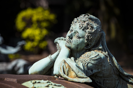 5 JUNE 2018, MILAN, ITALY: Statues of mourning at the graves of the monumental cemetery in Milan.のeditorial素材