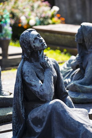5 JUNE 2018, MILAN, ITALY: Statues of mourning at the graves of the monumental cemetery in Milan.のeditorial素材