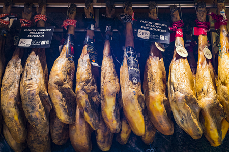 BARCELONA, SPAIN - 11 JANUARY 2018: The old grocery market of Barcelona Boqueria selling food jamon vegetables for tourists and visitors to the city.のeditorial素材