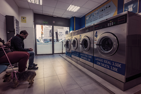 MADRID, SPAIN - 27 MARCH, 2018: Public laundry with mashinam for a street in the city of Madrid.のeditorial素材